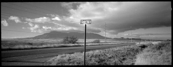 In this Oct. 26, 2021 photo, a street sign leads to where once was the home of Paul Adams and his family on the outskirts of Bisbee, Arizona, Oct. Adams, a Mormon and U.S. Border Patrol agent living with his wife and six children admitted he had posted videos on the dark web of him molesting two of his children, a nine-year-old girl and a younger daughter he began raping when she was only six months old. Adams committed suicide after his arrest. The revelation that Mormon officials directed an effort to conceal years of abuse in the Adams household sparked a criminal investigation of the Church by Cochise County Attorney and a civil lawsuit by three of the Adams Children. (AP Photo/Dario Lopez-Mills)