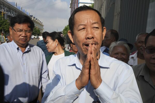 Cambodian prominent opposition politician Rong Chhun greets his supporters near the Phnom Penh Municipal Court in Phnom Penh, Cambodia, Monday, May 5, 2025. (AP Photo/Heng Sinith)