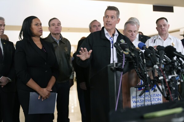 Transportation Secretary Sean Duffy, with District of Columbia Mayor Muriel Bowser, left, and other officials, speaks during a news conference at Ronald Reagan Washington National Airport, Thursday morning, Jan. 30, 2025, in Arlington, Va. (AP Photo/Mark Schiefelbein)