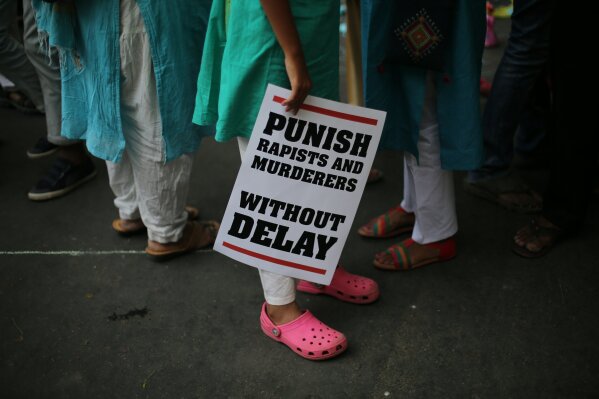FILE - In this Sunday, April 15, 2018, file photo, Indian protestors display placards during a protest against two recently reported rape cases as they gather near the Parliament in New Delhi, India. The gang rape and death of a woman from the lowest rung of India’s caste system sparked an outrage across the country on Wednesday, Sept. 30, 2020, with several politicians and activists demanding justice and protesters rallying on the streets. The 19-year-old woman’s death is the latest gruesome case of sexual violence against women to rile India, where reports of rape are hauntingly familiar. (AP Photo/Oinam Anand, File)