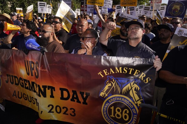 FILE - UPS teamsters and workers hold a rally in downtown Los Angeles, Wednesday, July 19, 2023, as a national strike deadline nears. The Teamsters said Wednesday that they will resume contract negotiations with UPS next week, marking an end to a stalemate that began two weeks ago when both sides walked away from talks while blaming each other. (AP Photo/Damian Dovarganes, File)