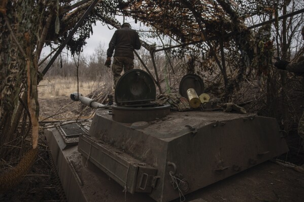 Ukrainian soldiers prepare a self-propelled artillery vehicle Gvozdika to fire towards the Russian positions on the frontline in the Donetsk region, Ukraine, Friday, Feb. 16, 2024. (Roman Chop via AP)