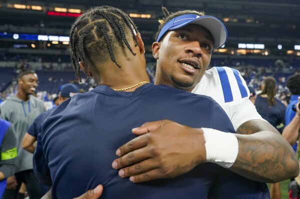 Indianapolis Colts quarterback Anthony Richardson, right, hugs Chicago Bears quarterback Justin Fields after an NFL preseason football game in Indianapolis, Saturday, Aug. 19, 2023. The Colts won 24-17. (AP Photo/Darron Cummings)