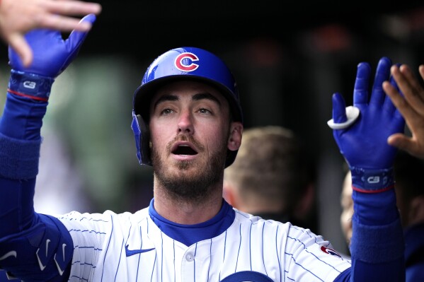 Chicago Cubs' Cody Bellinger celebrates with teammates after hitting a solo home run during the sixth inning of a baseball game against the Los Angeles Dodgers in Chicago, Sunday, April 7, 2024. (AP Photo/Nam Y. Huh)