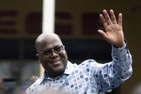 FILE - Congo's President Felix Tshisekedi waves to his supporters after casting his ballot inside a polling station during the presidential elections in Kinshasa, Democratic Republic of Congo, Wednesday, Dec. 20, 2023. Congo’s constitutional court has upheld the results of last month’s election that declared President Felix Tshisekedi the winner, rejecting a petition to annul the vote. The court called a petition by opposition candidate, Theodore Ngoy to redo the vote unfounded. Ngoy, who finished with less than 1% of the vote, was the only candidate to file an appeal. (AP Photo/Mosa'ab Elshamy, File)
