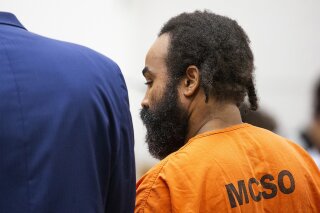 FILE - In this Feb. 5, 2019, file pool photo, Nathan Sutherland, accused of raping and impregnating a patient at Hacienda HealthCare, is arraigned in Maricopa County Superior Court in Phoenix, Ariz. The rape of an incapacitated woman at this facility is driving Arizona to catch up to 10 states with laws or regulations governing electronic monitoring and other technology aimed at deterring abuse inside long-term care facilities. Renewed attention on safeguarding vulnerable residents at care centers comes after an incapacitated woman gave birth at the Phoenix facility in Dec. 2018. (Tom Tingle/The Arizona Republic via AP, Pool, File)