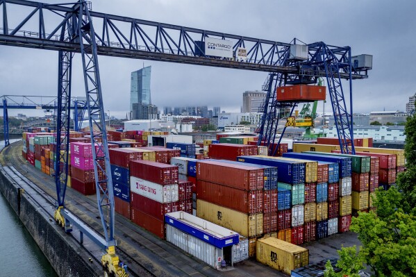 FILE - Containers are pictured in the harbor in Frankfurt, Germany, on July 28, 2023. The world economy is losing momentum in the face of higher interest rates, the ongoing war in Ukraine and widening geopolitical rifts, the International Monetary Fund warned Tuesday Oct. 10, 2023. (AP Photo/Michael Probst, File)