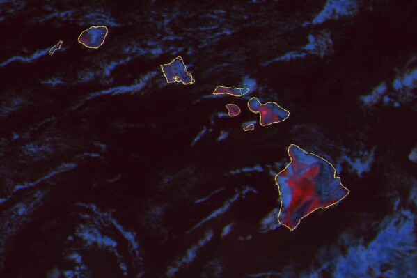 This GOES-18 fire temperature composite satellite image taken 6:30 p.m. EDT. on Wednesday, Aug. 9, 2023 and released by NOAA, shows hot land surface temperatures in red on the Hawaii Islands. A dangerous mix of conditions appear to have combined to make the wildfires blazing a path of destruction in Hawaii particularly damaging, including high winds, low humidity and dry vegetation. (NOAA via AP)