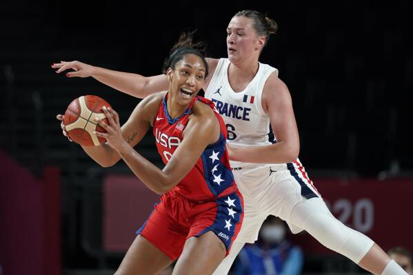 United States' A'Ja Wilson (9), left, passes ahead of France's Alexia Chartereau (6) during women's basketball preliminary round game at the 2020 Summer Olympics, Monday, Aug. 2, 2021, in Saitama, Japan. (AP Photo/Charlie Neibergall)