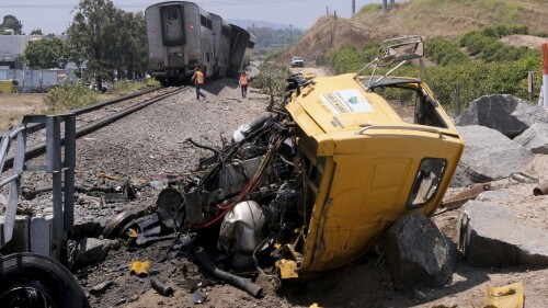 A destroyed truck lies next to a derailed Amtrak train in Moorpark, Calif., on Wednesday, June 28, 2023. Authorities say an Amtrak passenger train carrying 190 passengers derailed after striking a vehicle on tracks in Southern California. Only minor injuries were reported. (Dean Musgrove /The Orange County Register via AP)