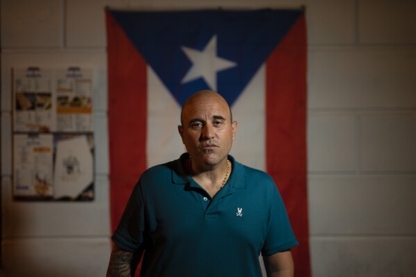 Jose Irizarry, a once-standout DEA agent sentenced to more than 12 years in federal prison for conspiring to launder money with a Colombian cartel, stands for a portrait during an interview the night before going to a federal detention center, in San Juan, Puerto Rico, Wednesday, Jan. 5, 2022. (AP Photo/Carlos Giusti, File)
