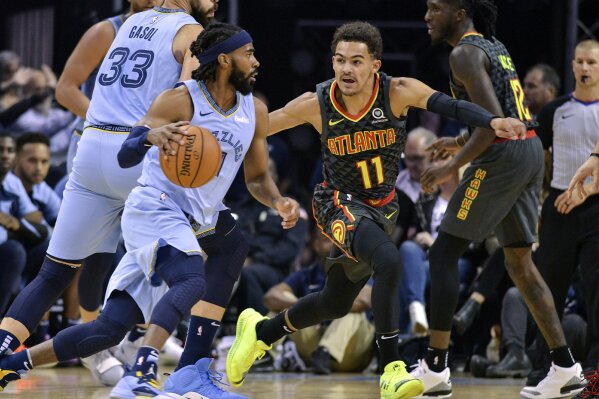 
              Memphis Grizzlies guard Mike Conley, left, drives against Atlanta Hawks guard Trae Young (11) in the first half of an NBA basketball game Friday, Oct. 19, 2018, in Memphis, Tenn. (AP Photo/Brandon Dill)
            