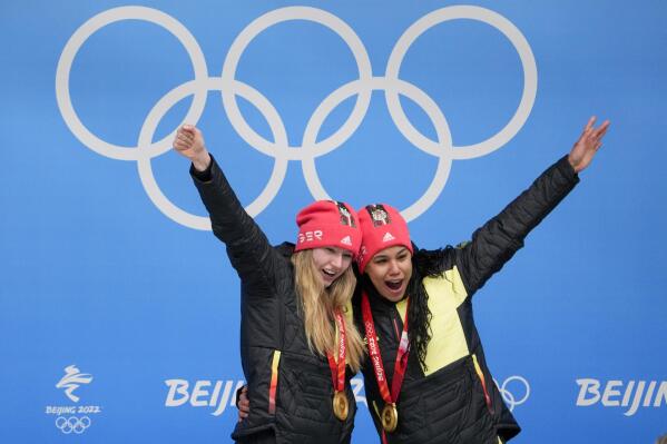 Laura Nolte and Deborah Levi, of Germany, celebrate winning the gold medal in the women's bobsleigh at the 2022 Winter Olympics, Saturday, Feb. 19, 2022, in the Yanqing district of Beijing. (AP Photo/Pavel Golovkin)