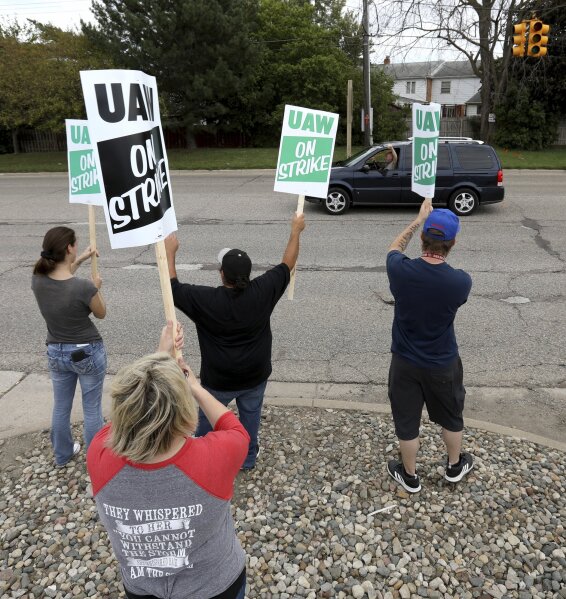 Members of UAW Local 598 wave to passing cars honking in support on Van Slyke Road in front of the General Motors Flint Assembly plant in Flint, Michigan on Sunday, September 15, 2019. The United Auto Workers union announced Sunday that its workers at General Motors plants in the U.S. would go on strike just before midnight because contentious talks on a new contract had broken down. (Eric Seals/Star Tribune via AP)