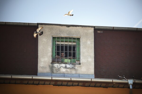 A inmate watches the 13th edition of the Inter-Prison Boxing Tournament from his prison cell in Sofia Central Prison, Sofia, Tuesday, June 3, 2025. (AP Photo/Valentina Petrova)