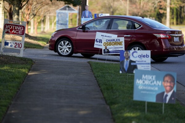 A Super Tuesday voter drives into the entrance to a polling location Tuesday, March 5, 2024, in Charlotte, N.C. (AP Photo/Chris Carlson)