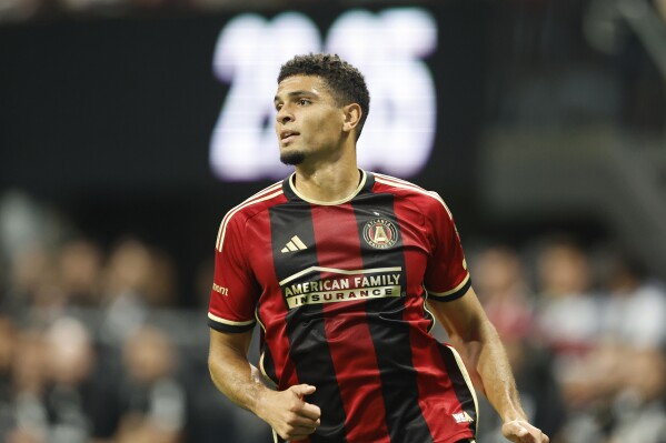 FILE - Atlanta United's Miles Robinson (12) runs during the first half of an MLS soccer match against DC United, Saturday, June 10, 2023, in Atlanta. U.S. national team defender Mile Robinson signed a one-year contract with Major League Soccer's Cincinnati, leaving Atlanta after seven seasons. The deal includes a team option for 2025, Cincinnati said Wednesday, Jan. 3, 2024. (AP Photo/Stew Milne, File)