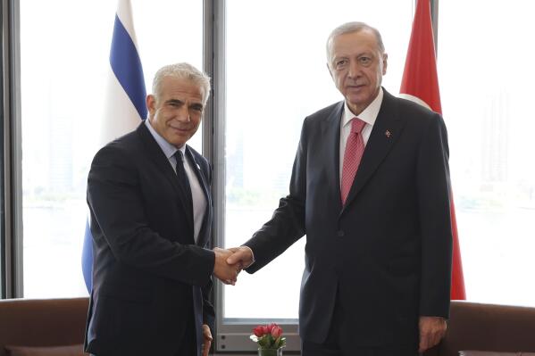 In this photo provided by the Turkish Presidency, Turkey's President Recep Tayyip Erdogan, right, shakes hands with Israeli Prime Minister Yair Lapid during their meeting on the sidelines of the United Nations General Assembly in New York, US, Tuesday, Sept. 20, 2022. (Turkish Presidency via AP)