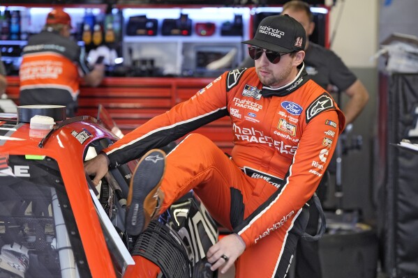 FILE - Chase Briscoe climbs into his car during a practice session for the NASCAR Daytona 500 auto race Friday, Feb. 16, 2024, at Daytona International Speedway in Daytona Beach, Fla. Owners Tony Stewart and Gene Haas announced this week that the four-team garage would cease operations at the end of the season, leaving the future up in the air for Briscoe and teammates Josh Berry, Noah Gragson and Ryan Preece. (AP Photo/Chris O'Meara, File)