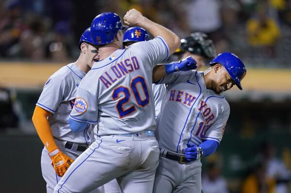 New York Mets' Eduardo Escobar, right, celebrates with Pete Alonso after hitting a grand slam against the Oakland Athletics during the fifth inning of a baseball game in Oakland, Calif., Friday, Sept. 23, 2022. (AP Photo/Godofredo A. Vásquez)