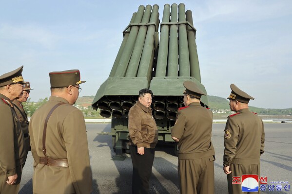 In this photo provided by the North Korean government, North Korean leader Kim Jong Un, center, supervises a test firing of a new multiple rocket launch system at an undisclosed place in North Korea on May 10, 2024. Independent journalists were not given access to cover the event depicted in this image distributed by the North Korean government. The content of this image is as provided and cannot be independently verified. Korean language watermark on image as provided by source reads: 