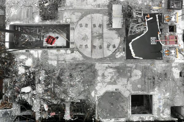 This Jan. 31, 2014, image released by Tokyo Electric Power Company Holdings shows the aerial view of the No. 3 reactor, with its roof blown off and shield plug (circle in the middle) exposed, in Okuma town, Fukushima prefecture, northeastern Japan. A draft investigation report into the 2011 Fukushima nuclear meltdown, adopted by Japanese nuclear regulators Wednesday, Jan. 27, 2021, says it has detected dangerously high levels of radioactive contamination at two of the three reactors, adding to concerns about decommissioning challenges.(Tokyo Electric Power Company Holdings via AP)