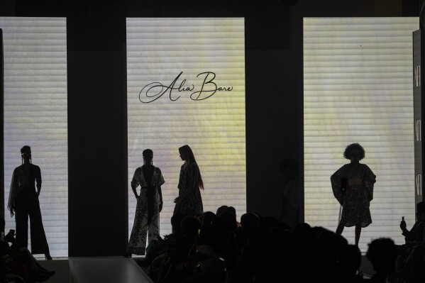 Models stand on the catwalk during Niger's designer Alia Bare show during Johannesburg Fashion Week 2023 in Johannesburg, South Africa, Thursday, Nov. 9, 2023. (AP Photo/Jerome Delay)