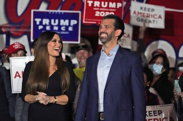 FILE - IN this Nov. 5, 2020 file photo, Donald Trump Jr., right, smiles along with his girlfriend Kimberly Guilfoyle prior to a news conference at Georgia Republican Party headquarters in Atlanta. The couple spent nearly $10 million this week, Thursday, April 1, 2021,  to buy a 11,000-square-foot, six-bedroom, 11-bath mansion in the town of Jupiter, Fla. That's about 20 miles from the Mar-a-Lago compound where former President Donald Trump and former first lady Melania Trump are living. (AP Photo/John Bazemore, File)