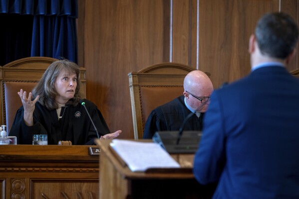 New Mexico Supreme Court Chief Justice Shannon Bacon, left, and Justice David Thomson question attorney Carter Harrison, representing the Republican Party of New Mexico, during oral arguments of an appeal for the redrawn borders of New Mexico's Congressional District 2, Monday, Nov. 20, 2023. (Eddie Moore/The Albuquerque Journal via AP)