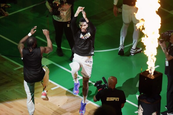 Boston Celtics' Jaylen Brown, left, and Jayson Tatum jump before Game 1 of the basketball team's NBA Finals against the Dallas Mavericks on Thursday, June 6, 2024, in Boston. (AP Photo/Michael Dwyer)