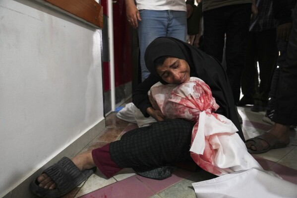 A Palestinian woman mourns her son, killed in an Israeli airstrikes in Jabalia, northern Gaza Strip, on Wednesday, May 14, 2025. According to local hospitals, 48 people were killed in the strikes, including 22 children. (AP Photo/Jehad Alshrafi)