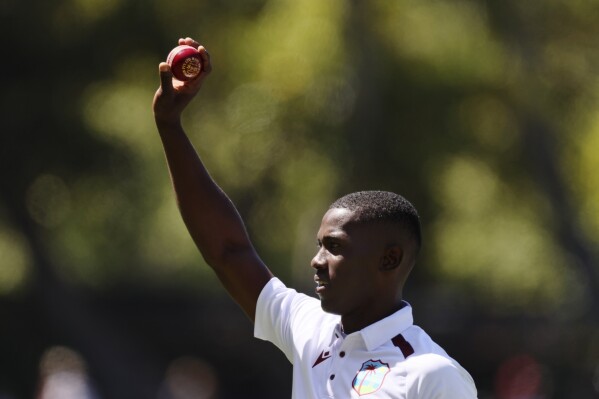 West Indies' Shamar Joseph holds up the ball after taking 5 wickets against Australia on the second day of their cricket test match in Adelaide, Australia, Thursday, Jan. 18, 2024. (APPhoto/James Elsby)