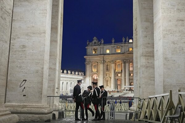 Police officers speak in St. Peter's Square ahead of the funeral of Pope Francis at the Vatican, Saturday, April 26, 2025. (AP Photo/Andreea Alexandru)