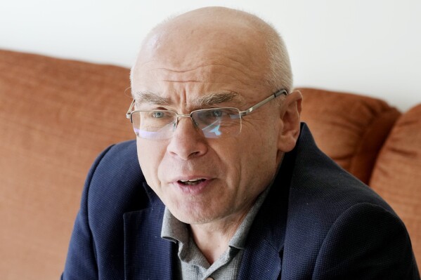 Historian Dariusz Stola, who worked with the anti-communist underground movement Solidarity in the 1980s, speaks to The Associated Press in his home in Warsaw, Poland, on Friday, Oct. 6, 2023. As a historian and a former dissident, Stola sees parallels between the way the communist authorities and Poland's populist leaders use propaganda and distort the truth for political ends. Concerns about democracy are driving the choice of many Poles as they prepare to vote in a national election Sunday viewed as the most important one since 1989. (AP Photo/Czarek Sokolowski)