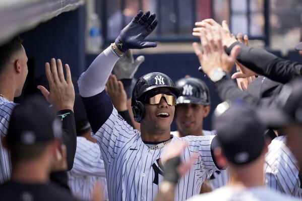 New York Yankees' Juan Soto celebrates after hitting a home run in the fourth inning of a spring training baseball game against the Atlanta Braves Sunday, March 10, 2024, in Tampa, Fla. (AP Photo/Charlie Neibergall)
