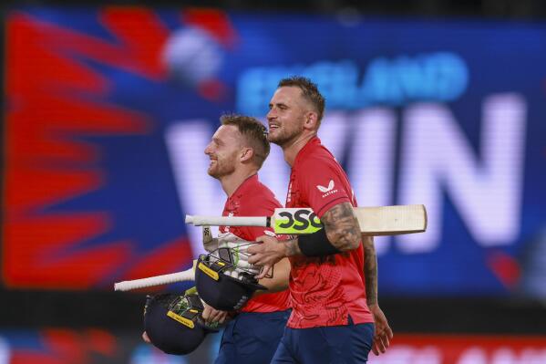 England's Jos Buttler, left, and Alex Hales walk from the field after the T20 World Cup cricket semifinal between England and India in Adelaide, Australia, Thursday, Nov. 10, 2022. England defeated India by ten wickets. (AP Photo/James Elsby)