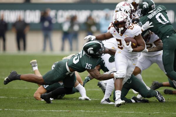 Minnesota's Mohamed Ibrahim (24) rushes against Michigan State's Angelo Grose (15) during the first half of an NCAA college football game, Saturday, Sept. 24, 2022, in East Lansing, Mich. Minnesota won 34-7. (AP Photo/Al Goldis)