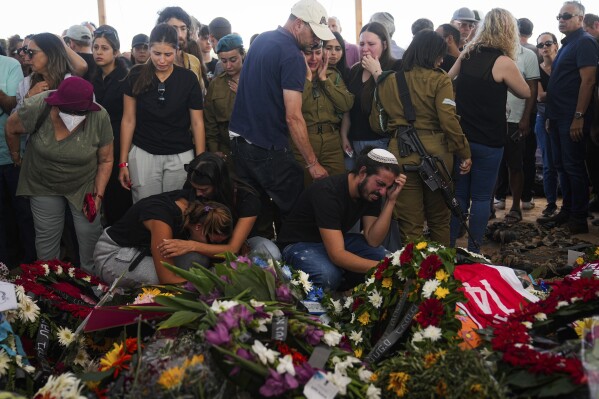Mourners attend the funeral of the Kotz family in Gan Yavne, Israel, Tuesday, Oct. 17, 2023. (AP Photo/Ohad Zwigenber)