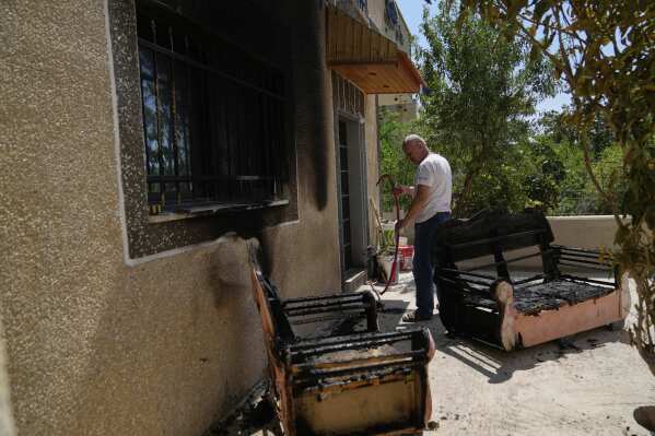 Palestinian landlord Akram Sabra, 60, inspects his house, burnt overnight by Israeli settlers in an attack that left several burnt vehicles and damaged homes, residents said, in the West Bank village of Bruqin, near Salfit, Friday, May 23, 2025. (AP Photo/Nasser Nasser)