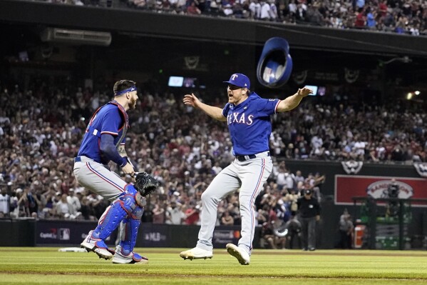 Texas Rangers catcher Jonah Heim, left, and relief pitcher Josh Sborz celebrate after Game 5 of the baseball World Series against the Arizona Diamondbacks Wednesday, Nov. 1, 2023, in Phoenix. The Rangers won 5-0 to win the series 4-1. (AP Photo/Godofredo A. Vásquez)