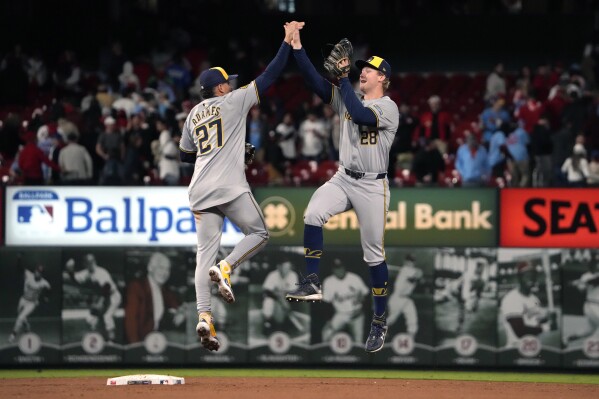 Milwaukee Brewers' Joey Wiemer (28) and Willy Adames (27) celebrate a 2-1 victory over the St. Louis Cardinals in a baseball game Friday, April 19, 2024, in St. Louis. (AP Photo/Jeff Roberson)