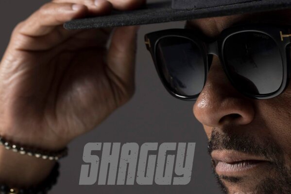 This cover image released by Ranch Entertainment shows "Hot Shot 2020" by Shaggy.  In 2000 reggae artist Shaggy dominated pop radio with his ubiquitous No. 1 hits, “It Wasn't Me" and “Angel." Twenty years later, he's celebrating the album that featured those songs, “Hot Shot," by re-releasing the project and including updated versions of his hits. “Hot Shot 2020" will be available Friday. (Ranch Entertainment via AP)