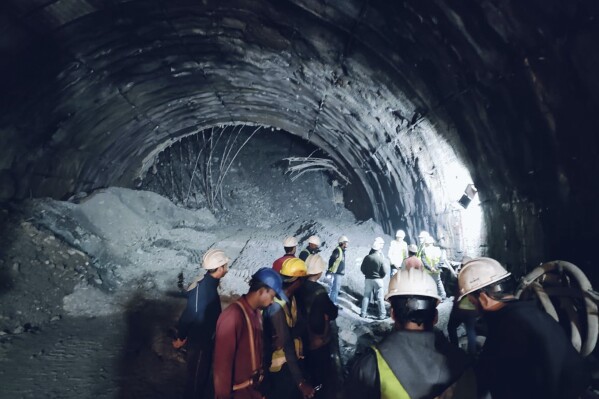 This photo provided by Uttarakhand State Disaster Response Force (SDRF) shows rescuers inside a collapsed road tunnel where more than 30 workers were trapped by a landslide in northern in Uttarakhand state, India, Sunday, Nov.12, 2023. ( SDRF via AP)