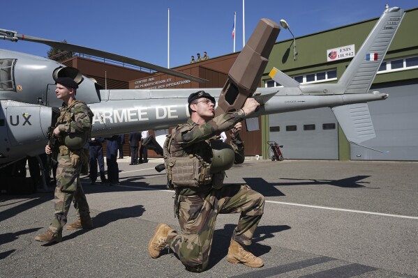 A soldier uses a wave jammer during a demonstration on anti-drone fight at the Air Base 942 of Lyon-Mont Verdun, central France, Friday, March 22, 2024 in Poleymieux-au-Mont-d'Or. French Prime Minister Gabriel Attal visited the base as part of the Paris 2024 Olympic Games security plan. (AP Photo/Laurent Cipriani)