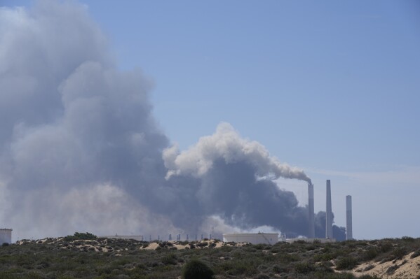 Smoke rises from an area near a power plant outside Ashkelon, Israel, on Saturday, Oct. 7, 2023. Palestinian militants in the Gaza Strip infiltrated Saturday into southern Israel and fired thousands of rockets into the country while Israel began striking targets in Gaza in response. (AP Photo/Ohad Zwigenberg)