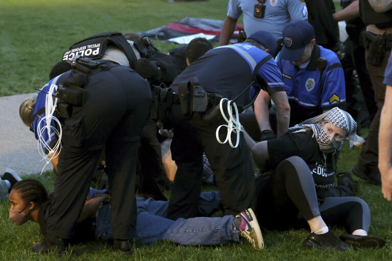 Police arrest pro-Palestinian protesters attempting to camp on Washington University's campus, Saturday, April 27, 2024, in St. Louis, Mo. (Christine Tannous/St. Louis Post-Dispatch via AP)