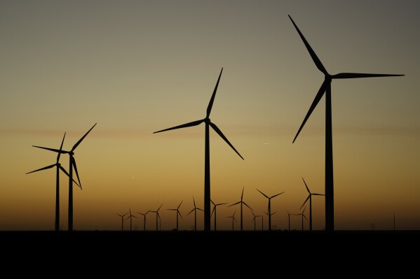 Wind turbines stretch across the horizon at dusk at the Spearville Wind Farm, Sept. 29, 2024, near Spearville, Kan. (AP Photo/Charlie Riedel, File)
