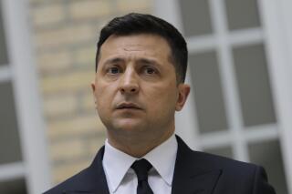 Ukrainian President Volodymyr Zelenskyy looks on during a press conference at the Ukrainian Embassy to France, Friday, April 16, 2021, in Paris. Ukrainian President Volodymyr Zelenskyy held talks with French President Emmanuel Macron and German Chancellor Angela Merkel amid his country's growing tensions with neighboring Russia, which has deployed troops near its border with Ukraine. (AP Photo/Lewis Joly)