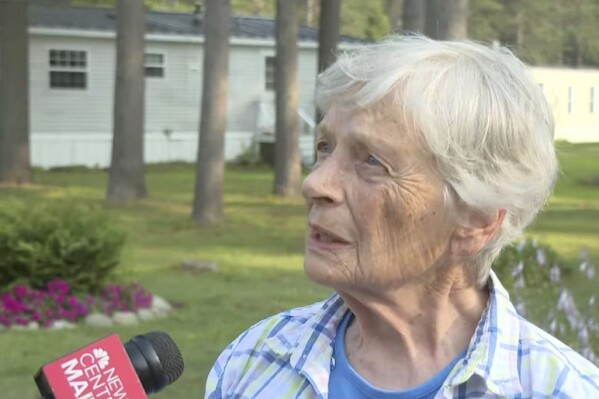 Marjorie Perkins speaks to a reporter Wednesday, Aug. 2, 2023, at her home in Brunswick, Maine. Perkins, 87, was left bruised after police said a teenager broke into her home and attacked her. She fought off the intruder and gave him food before he fled. (News Center Maine via AP)