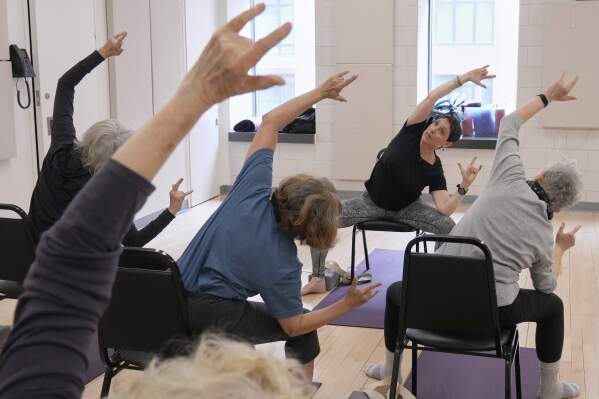 Whitney Chapman, right, conducts a chair yoga class at the Marlene Meyerson JCC Manhattan, in New York, March 28, 2025. (AP Photo/Richard Drew)
